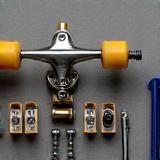 Close up of skateboard trucks, wheels, and tools laid out