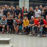Group of skateboarders watching a contest run