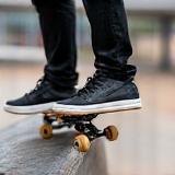 Skateboarder doing a grind trick on a rail